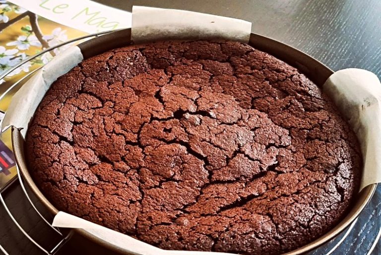 Flourless chocolate cake in a cake pan cake pan lined with non-stick paper